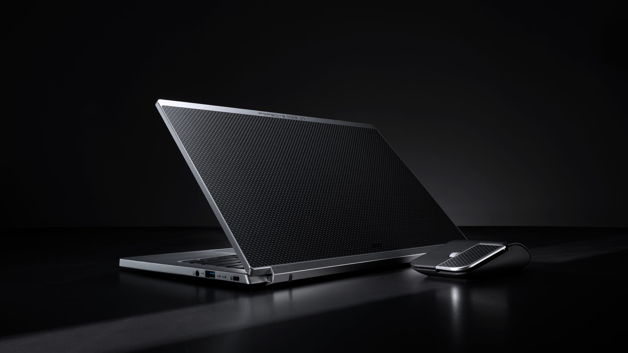 Porsche Design Acer Book RS open with cover facing reader with mouse