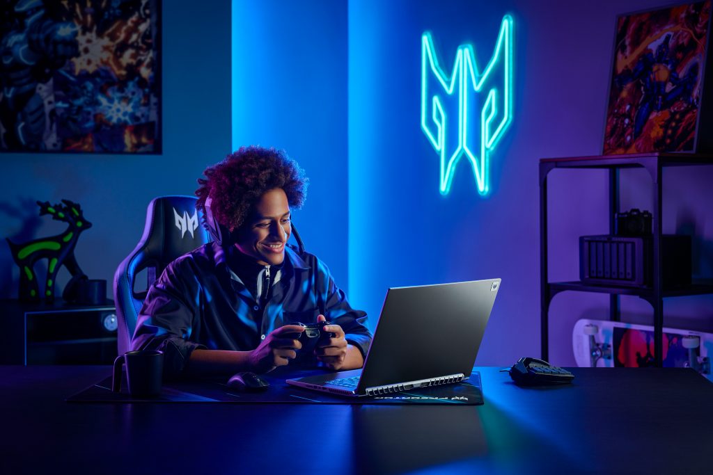 Gamer sitting in a dimly lit room in front of Acer Predator Triton 500 SE