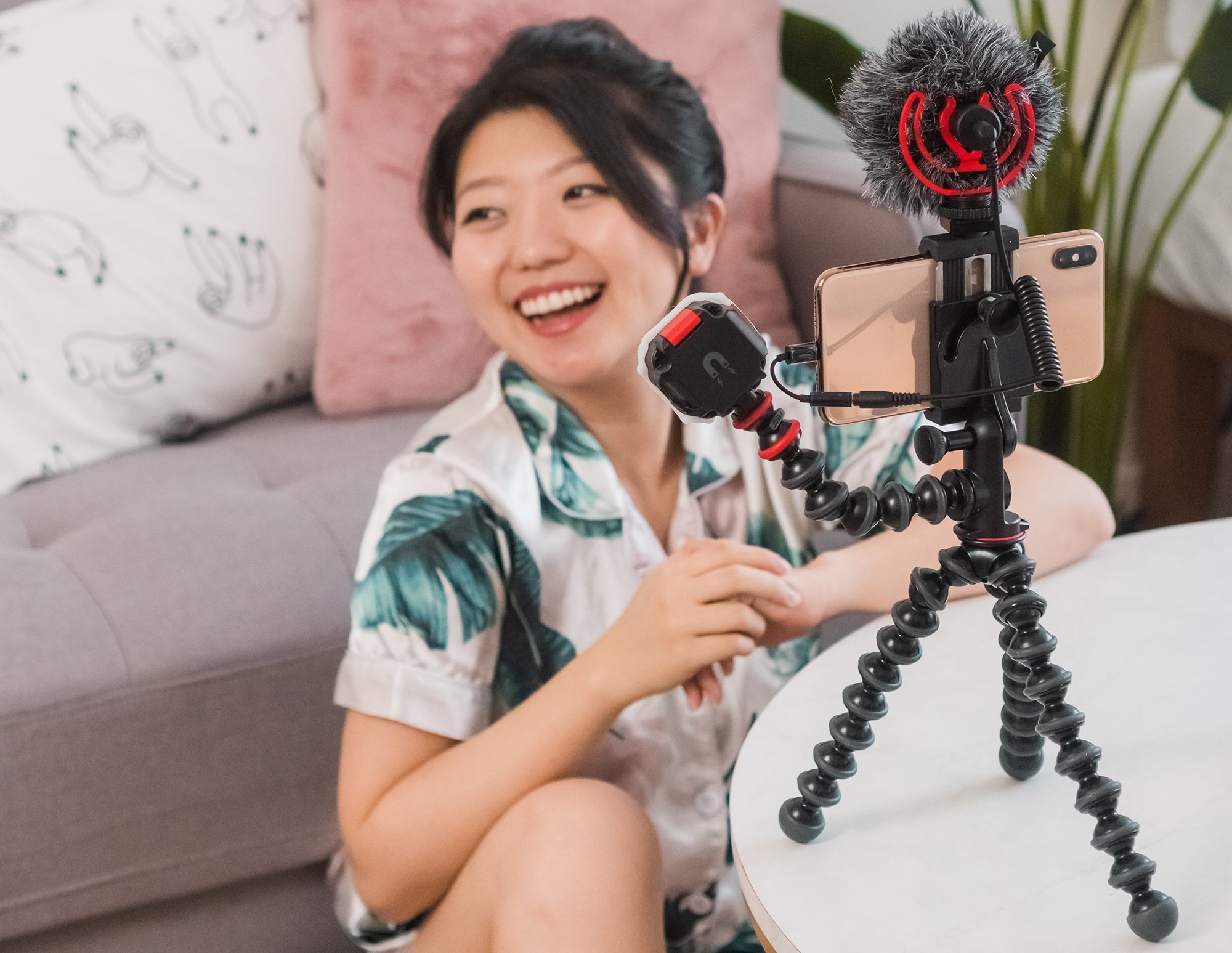 Woman sits smiling next to recording equipment