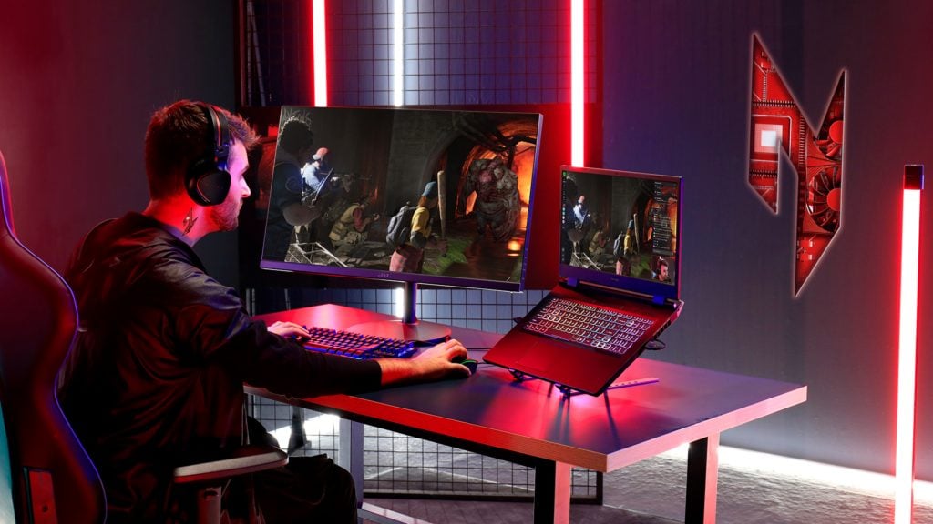 Man sitting in red-lit room in front of Acer Nitro 5