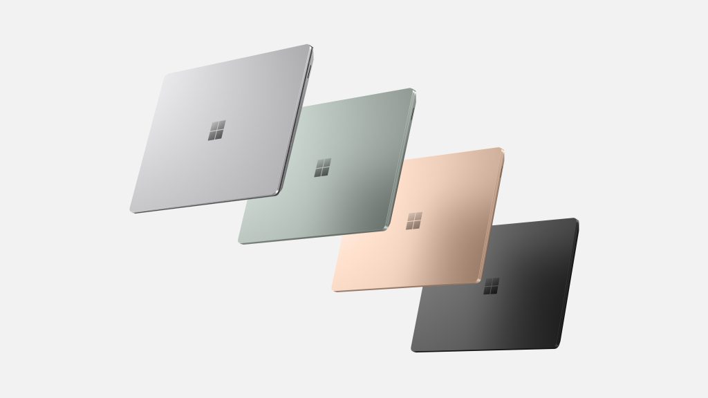 Four Surface Laptop 5 devices floating closed in a diagonal row